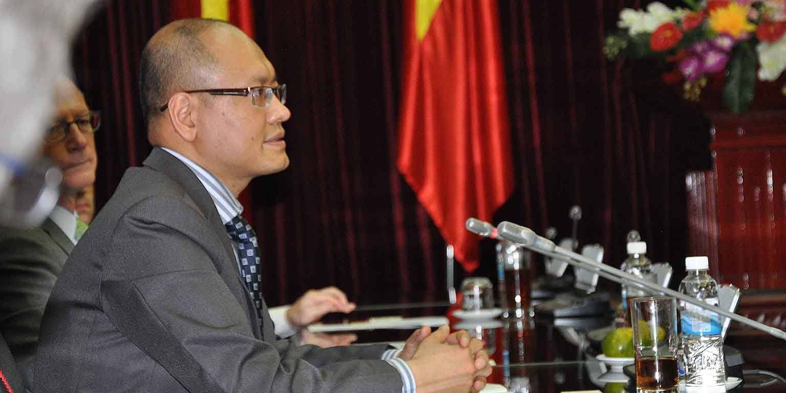 Man sits in front of many microphones.