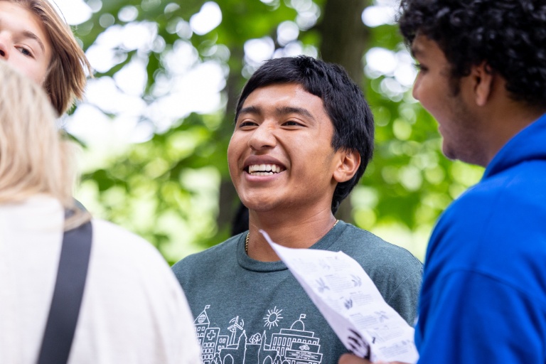 Three students walk on campus