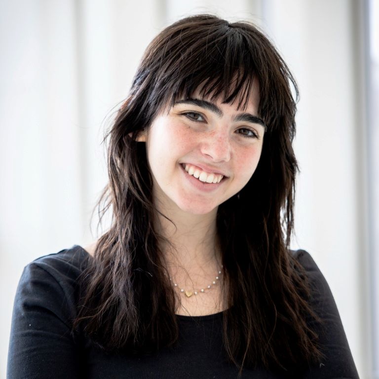 Headshot of smiling student in black top